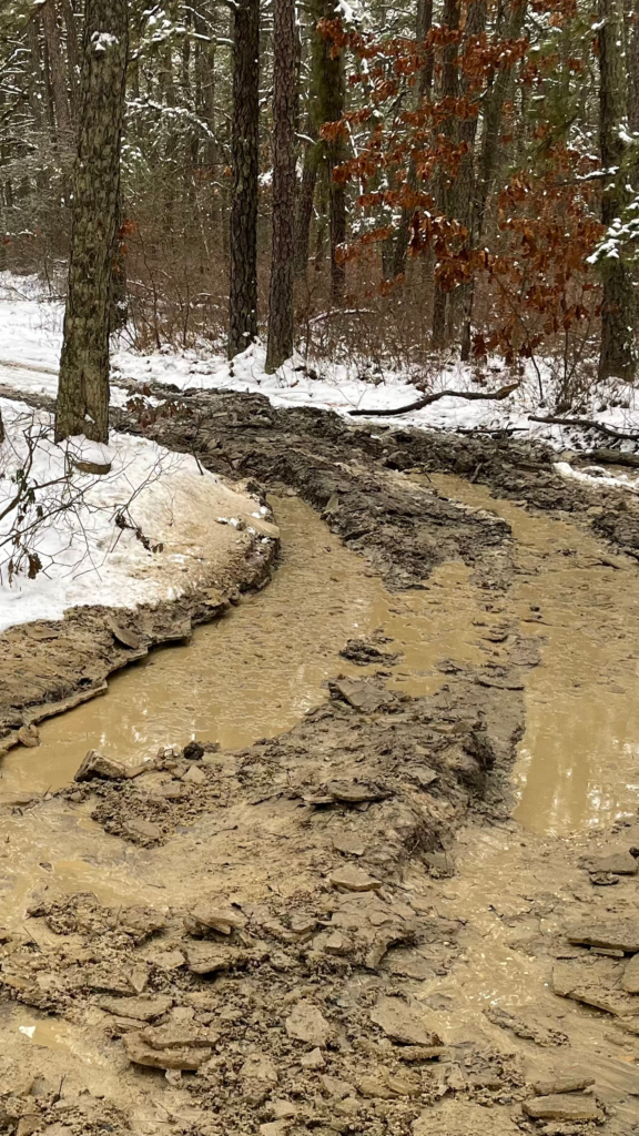 Photo of the deep mud and ruts under the snow where Daemon Adventures first got stuck.